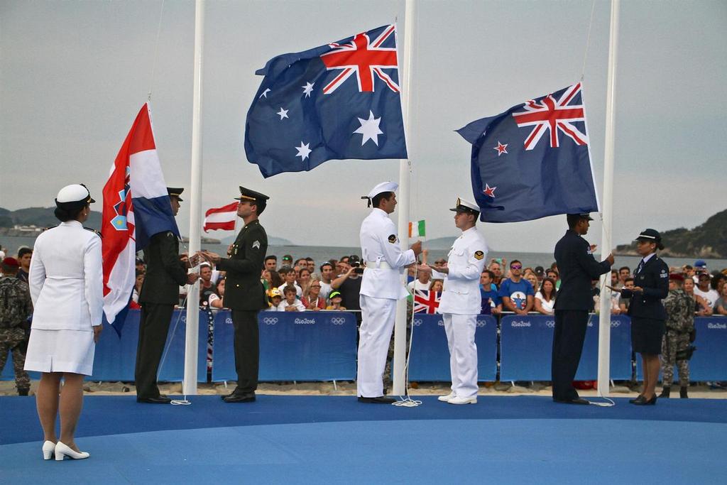The national flags are raised as part of the Medal Ceremony for the Mens Laser - 2016 Sailing Olympics © Richard Gladwell www.photosport.co.nz